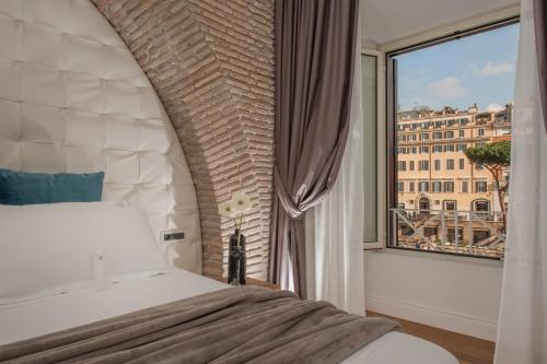 a bedroom with a bed and a large window at Argentina Residenza Style Hotel in Rome