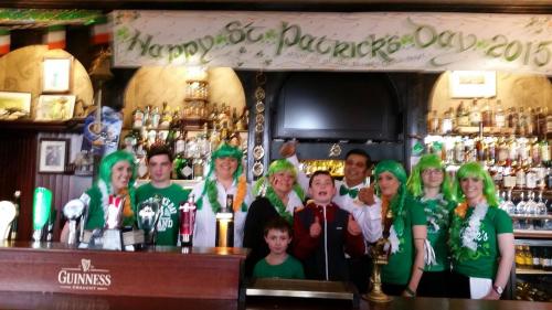 a group of people dressed up in green at a bar at Blarney Castle Hotel in Blarney