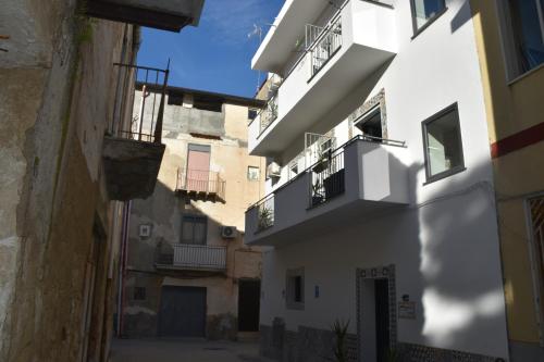 Un callejón en un casco antiguo con edificios blancos. en B&B Aurora, en Favara