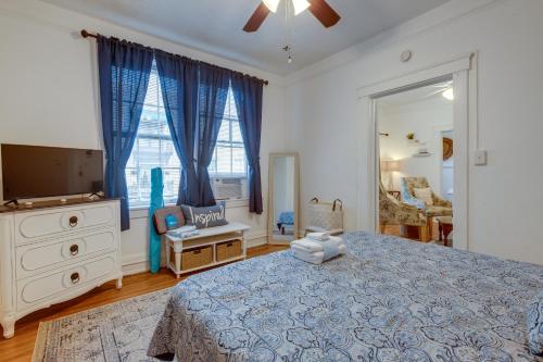 a bedroom with a bed and a dresser and a mirror at Walkable Savannah Escape in Historic District! in Savannah