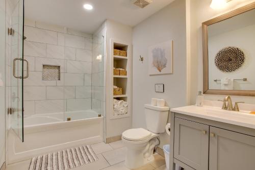 a bathroom with a toilet and a shower and a sink at Luxury Galveston Retreat - Walk to Pirates Beach! in Galveston