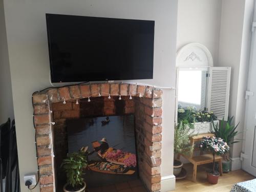 a fireplace with a tv on top of it at Central Derby pride park 4 bedrooms 7 beds -Spacious contractors large group -FREE PARKING in Derby