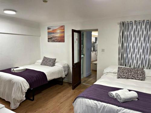 a hotel room with two beds and a window at Studio room in Brighton city centre in Brighton & Hove