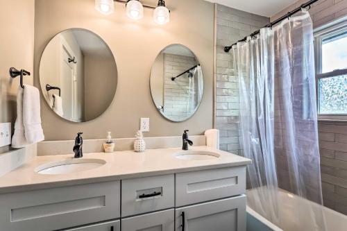 a bathroom with two sinks and two mirrors at Charming Retreat, 13 Mi to Grandfather Mtn! in Newland