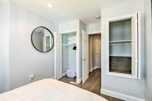 a white bedroom with a mirror and a bed at Central and Trendy Baltimore Townhome Pets OK! in Baltimore