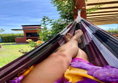 a woman laying in a hammock with her feet up at Cabañas Morita Mia in San Rafael