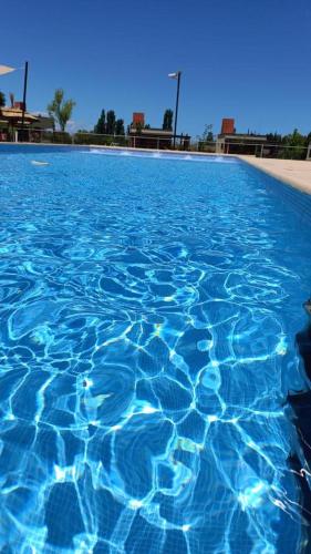 a large pool of blue water in a resort at Cabañas Morita Mia in San Rafael