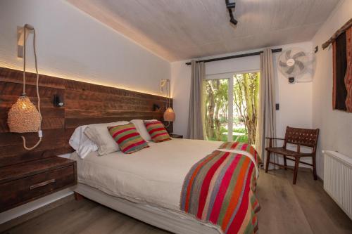 a bedroom with a bed and a window at Casa Solcor Boutique Bed & Breakfast in San Pedro de Atacama