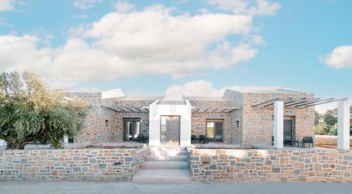 a brick house with a stone wall at PETRINO FOINIKOUNTA in Finikounta