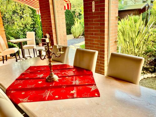 a table with a red cloth on top of it at B&B Desenzano Paradise in Desenzano del Garda
