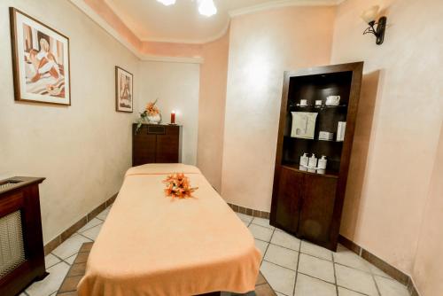 a room with a bed and a shelf with candles at SPA Hotel Jawor in Jaworze