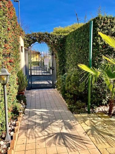 an entrance to a garden with an iron gate at B&B Desenzano Paradise in Desenzano del Garda