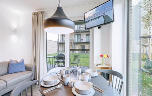 ein Wohnzimmer mit einem Tisch, einem Sofa und einem TV in der Unterkunft Cozy Apartment In Lembruchdümmer See in Lembruch