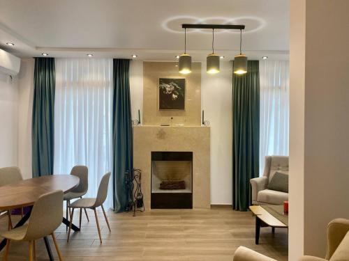 a living room with a table and a fireplace at European Village Old Villa 6 in Gonio