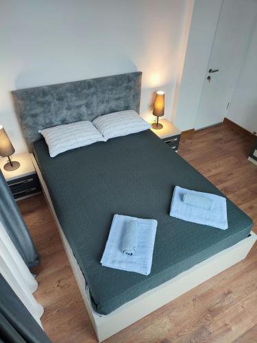 a bedroom with a large bed with two tables and two lamps at European Village Old Villa 6 in Gonio