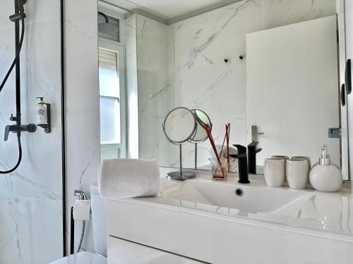 Baño blanco con lavabo y espejo en YOUROPO - Capela, en Oporto