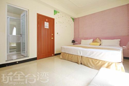 金湖鎮的住宿－伯爵四季休閒民宿，一间卧室设有一张大床和粉红色的墙壁