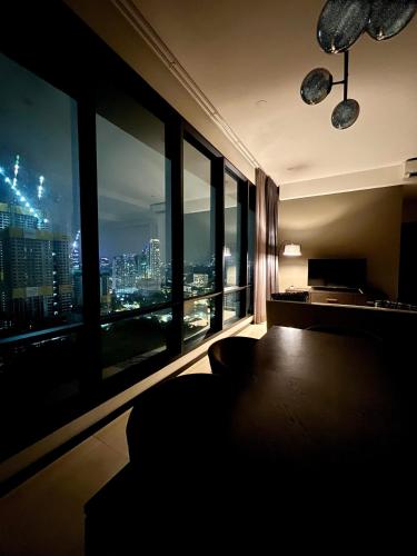 a room with a large window with a city view at Opus Residence KL by EUcation Home in Kuala Lumpur