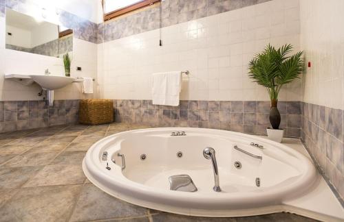 a bathroom with a large tub and a sink at ClickSardegna Villa Paraiba fronte mare per 12 persone in Alghero