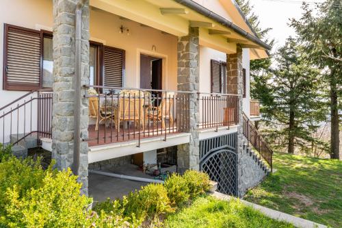 a house with a balcony with tables and chairs at Casa Vacanze Tuscan Retreat in Macchino
