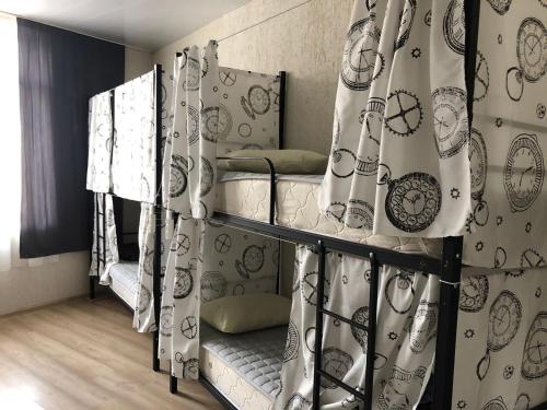 a room with two bunk beds with curtains at Sun city hostel in Yerevan