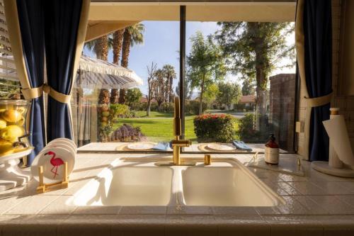 a kitchen sink in front of a window at Palm Desert Charm Permit# STR2022-0119 in Palm Desert