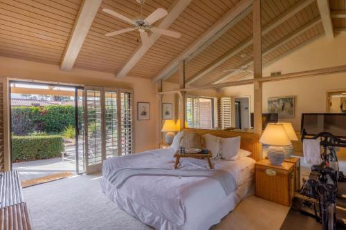 a bedroom with a bed and a ceiling fan at Palm Desert Charm Permit# STR2022-0119 in Palm Desert