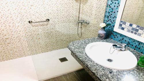 a bathroom with a sink and a shower at Welooveyou Zafiro's in Morro del Jable