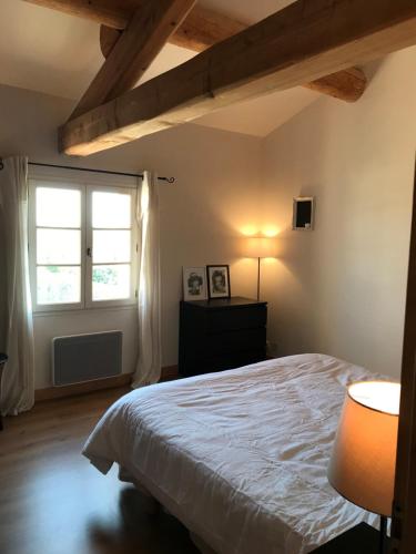 a bedroom with a large bed and a window at Maison Roquebeauresse in Pougnadoresse