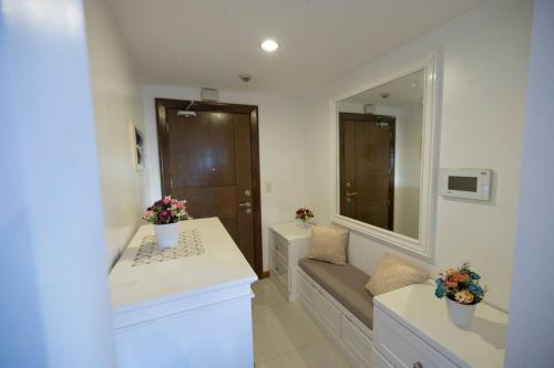 a bathroom with a sink and a large mirror at A2J Luxury 1BR Balcony Venice Suite Near Malls in Manila