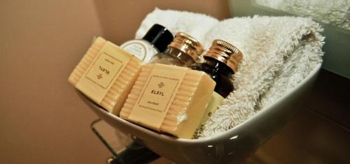 a bottle of essential oils and soap in a basket at New Farm Cheshire B&B in Winsford