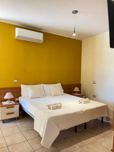 a bedroom with a bed with two towels on it at Sunway Apartments 2 in Alghero