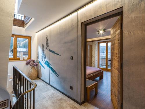 a hallway with a sliding glass door leading to a room with a bench at Ferienhaus Rauter in Oberndorf in Tirol