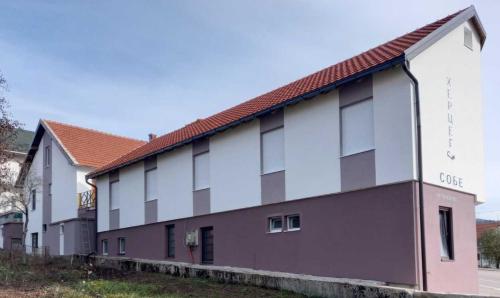 a building with a red roof at Apartmani Herceg in Gacko