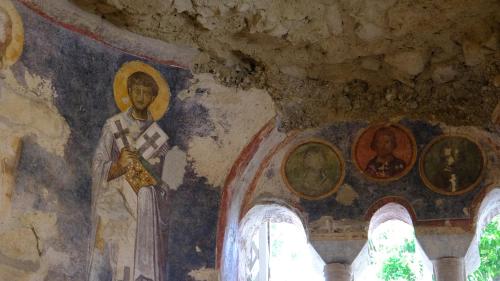 a painting of a church with a statue of a priest at Likya 202 in Demre