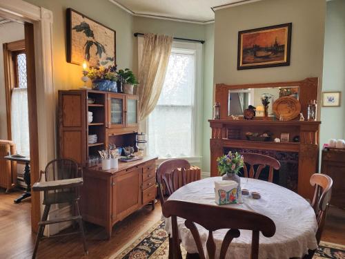 a dining room with a table and a mirror at The Fresh Coast Inn at Ludington in Ludington