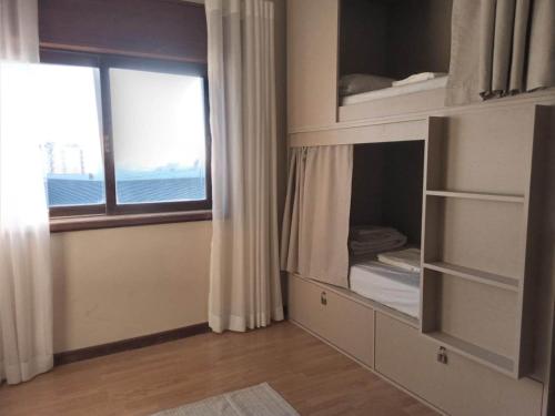 um quarto com um beliche e uma janela em Hostel Summer House em Vila Nova de Gaia