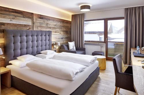 Postel nebo postele na pokoji v ubytování der grüne Baum Mountain Boutique Hotel