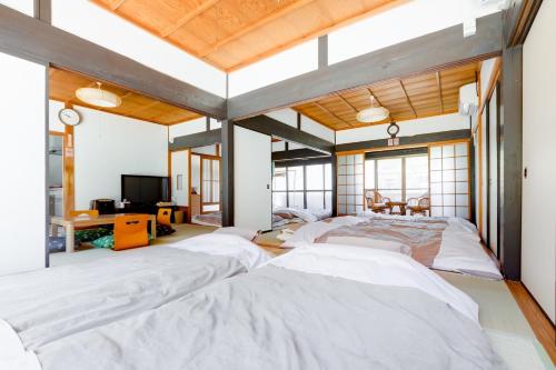 a large room with four beds in it at Yoshino-gun - House / Vacation STAY 36600 in Yoshino
