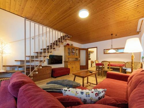 a living room with a couch and a staircase at Ferienwohnung in Triberg am Waldrand - idyllisch, ruhig, erholsam in Triberg