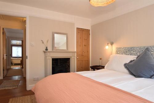 a bedroom with a bed and a fireplace at 5 East Street in Rye