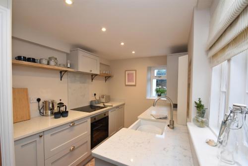 a kitchen with white cabinets and a counter top at 5 East Street in Rye