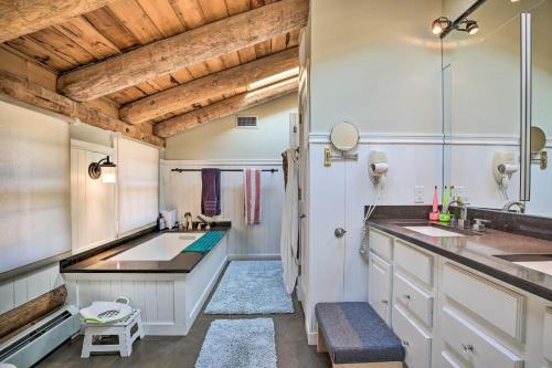 a bathroom with two sinks and a large mirror at Accord Vacation Rental with Pool and Hot Tub! in Accord