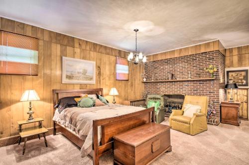 a bedroom with a bed and a brick wall at Charming Aiken Vacation Rental 2 Mi to Dtwn! in Aiken