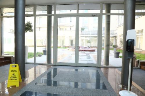 a lobby with a caution sign in the middle of a building at Modern apartment,24/7 security,free parking in Belgrade