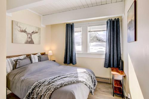 a bedroom with a bed and a window at Cozy Condo Near Golf, 7 Mi to Big Sky Resort! in Gallatin Gateway