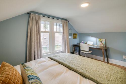 a bedroom with a bed and a window and a desk at Charming Tacoma Vacation Home with Fenced Yard in Tacoma