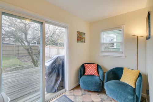 two chairs in a room with a sliding glass door at Charming Tacoma Vacation Home with Fenced Yard in Tacoma