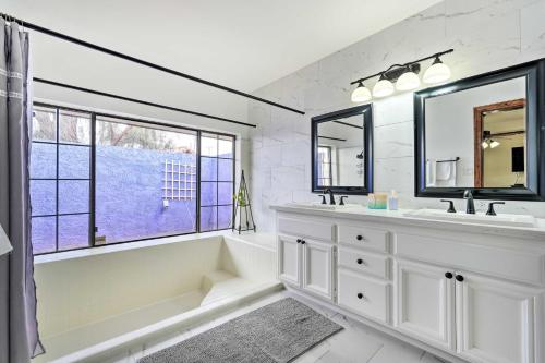 a white bathroom with a tub and a sink at Pet-Friendly Glendale Home with Pool and Putting Green in Phoenix