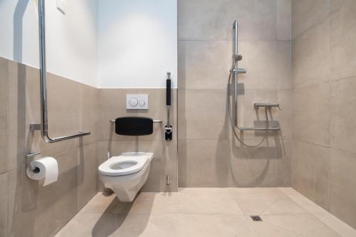 a bathroom with a toilet and a shower at b-smart motel Schaan in Schaan